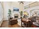 Cozy living room with a fireplace, high ceilings, and comfortable leather furniture at 503 Kensington Estates Trce, Woodstock, GA 30188