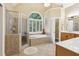 Luxurious main bathroom with walk-in shower, soaking tub, and dual sinks at 503 Kensington Estates Trce, Woodstock, GA 30188