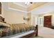 Spacious main bedroom with tray ceiling, ceiling fan, and access to the bathroom at 503 Kensington Estates Trce, Woodstock, GA 30188