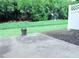 A concrete patio with potted plants overlooks the backyard's lawn, trees, and privacy fence at 5620 Moresby Ct, Alpharetta, GA 30022