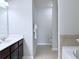 Primary bath boasts dual sinks, framed mirrors, and separate tub & toilet rooms at 5620 Moresby Ct, Alpharetta, GA 30022