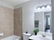 This bathroom offers a bathtub with tile surround and a vanity with decorative mirror and lighting at 5620 Moresby Ct, Alpharetta, GA 30022