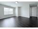 Clean bedroom with hardwood floors, window, and closet at 5620 Moresby Ct, Alpharetta, GA 30022