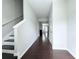 Entryway with dark wood floors and white walls, leading into the home at 5620 Moresby Ct, Alpharetta, GA 30022