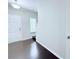 Hallway view showing stairs, dark wood floors and white trim at 5620 Moresby Ct, Alpharetta, GA 30022