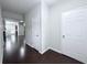 Hallway features dark wood flooring, with white doors and light gray walls at 5620 Moresby Ct, Alpharetta, GA 30022