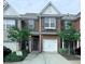 Charming brick townhome with a one car garage and well maintained front yard at 5620 Moresby Ct, Alpharetta, GA 30022