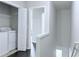 The upstairs hallway leads to the laundry room, featuring a washing machine and wire shelving at 5620 Moresby Ct, Alpharetta, GA 30022