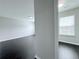 View of hallway with hardwood floors leading to bedroom with window at 5620 Moresby Ct, Alpharetta, GA 30022