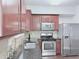 Modern kitchen with stainless steel appliances and dark countertops for a sleek look at 5620 Moresby Ct, Alpharetta, GA 30022