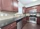 Well-lit kitchen with stainless steel appliances, dark countertops, and updated cabinetry at 5620 Moresby Ct, Alpharetta, GA 30022
