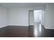 Open-concept living room with dark hardwood floors and gray walls at 5620 Moresby Ct, Alpharetta, GA 30022