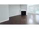 Open-concept living room with fireplace, dark hardwood floors, and gray walls at 5620 Moresby Ct, Alpharetta, GA 30022
