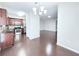 Open-concept living area with hardwood floors connecting kitchen and living spaces at 5620 Moresby Ct, Alpharetta, GA 30022