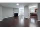 Open-concept living room with fireplace, dark hardwood floors, and gray walls at 5620 Moresby Ct, Alpharetta, GA 30022