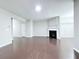 Spacious living room with dark hardwood floors, fireplace and open layout at 5620 Moresby Ct, Alpharetta, GA 30022