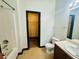 Bathroom including a shower, toilet, and vanity, plus a walk-in closet with wood-look flooring at 225 Colser Dr, Covington, GA 30016