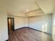 Bright bedroom featuring wood-look flooring, tray ceiling, and natural light at 225 Colser Dr, Covington, GA 30016