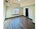 Bedroom showcasing wood-look floors, a window, and modern decor at 225 Colser Dr, Covington, GA 30016