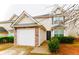 Charming two-story home featuring a stone-accented garage and well-maintained landscaping at 225 Colser Dr, Covington, GA 30016