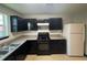 Functional kitchen featuring dark cabinetry, laminate countertops, and gas range at 225 Colser Dr, Covington, GA 30016