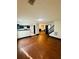 Spacious living area featuring hardwood floors, open layout to kitchen and stairs at 225 Colser Dr, Covington, GA 30016