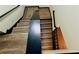 Modern staircase featuring wooden steps and a black railing at 225 Colser Dr, Covington, GA 30016