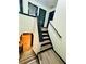 Staircase featuring two sets of stairs with modern wooden and black design at 225 Colser Dr, Covington, GA 30016