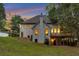 Stunning two-story house featuring an outdoor deck, green grass, and large windows that offer ample natural light at 2655 Boulder Creek Ne Dr, Roswell, GA 30075