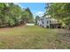 Expansive backyard featuring a lush lawn, patio and mature trees at 2655 Boulder Creek Ne Dr, Roswell, GA 30075