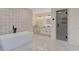 Expansive bathroom featuring a soaking tub, tiled accent wall, and glass enclosed shower with a matching tile pattern at 2655 Boulder Creek Ne Dr, Roswell, GA 30075