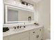 Stylish bathroom with a large, illuminated mirror, marble countertops, and matte black hardware at 2655 Boulder Creek Ne Dr, Roswell, GA 30075