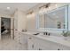 Bright bathroom features marble floors, a double vanity with an LED lighted mirror, and access to the main bedroom at 2655 Boulder Creek Ne Dr, Roswell, GA 30075