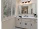 Bathroom featuring modern vanity with a large mirror and plantation shutters on the window at 2655 Boulder Creek Ne Dr, Roswell, GA 30075