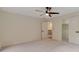 Large, carpeted bedroom featuring a ceiling fan and access to a walk-in closet at 2655 Boulder Creek Ne Dr, Roswell, GA 30075