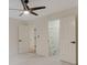 Neutral bedroom featuring a ceiling fan, carpeted floors, and closet with ladder at 2655 Boulder Creek Ne Dr, Roswell, GA 30075