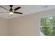 Angle shot of the bedroom with ceiling fan and backyard window view at 2655 Boulder Creek Ne Dr, Roswell, GA 30075