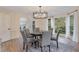 Elegant dining room featuring modern chandelier, with a large window offering natural light at 2655 Boulder Creek Ne Dr, Roswell, GA 30075