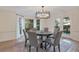 Elegant dining room featuring modern chandelier, with a large window offering natural light at 2655 Boulder Creek Ne Dr, Roswell, GA 30075