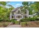 Two-story home with a stone entryway, large windows, and professionally landscaped front yard at 2655 Boulder Creek Ne Dr, Roswell, GA 30075