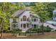 Two-story home with a stone entryway, large windows, and professionally landscaped front yard at 2655 Boulder Creek Ne Dr, Roswell, GA 30075
