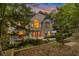 Eye-catching exterior with an arched window, mature trees, and landscaped gardens at 2655 Boulder Creek Ne Dr, Roswell, GA 30075