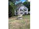 Charming two-story home with a lush green lawn and a beautiful tiered fountain at 2655 Boulder Creek Ne Dr, Roswell, GA 30075