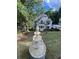 Charming two-story home with a lush green lawn and a beautiful tiered fountain at 2655 Boulder Creek Ne Dr, Roswell, GA 30075