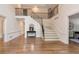 Spacious foyer with a wooden staircase, hardwood floors, and a stylish console table at 2655 Boulder Creek Ne Dr, Roswell, GA 30075