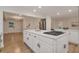 Modern kitchen with a large island, white cabinets, stainless steel appliances, and hardwood floors at 2655 Boulder Creek Ne Dr, Roswell, GA 30075