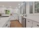Bright kitchen featuring white cabinetry, quartz countertops, a stainless steel dishwasher, and hardwood floors at 2655 Boulder Creek Ne Dr, Roswell, GA 30075