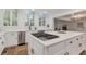 Bright kitchen with stainless appliances, skylights, quartz countertops, island cooktop and white cabinetry at 2655 Boulder Creek Ne Dr, Roswell, GA 30075