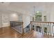 The bright landing features wood floors, wrought iron railings, and a large window for ample natural light at 2655 Boulder Creek Ne Dr, Roswell, GA 30075