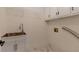 Functional laundry room with a utility sink, white cabinets, and tile flooring at 2655 Boulder Creek Ne Dr, Roswell, GA 30075